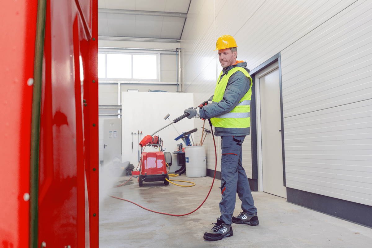 cleaning porta potty with pressure washer